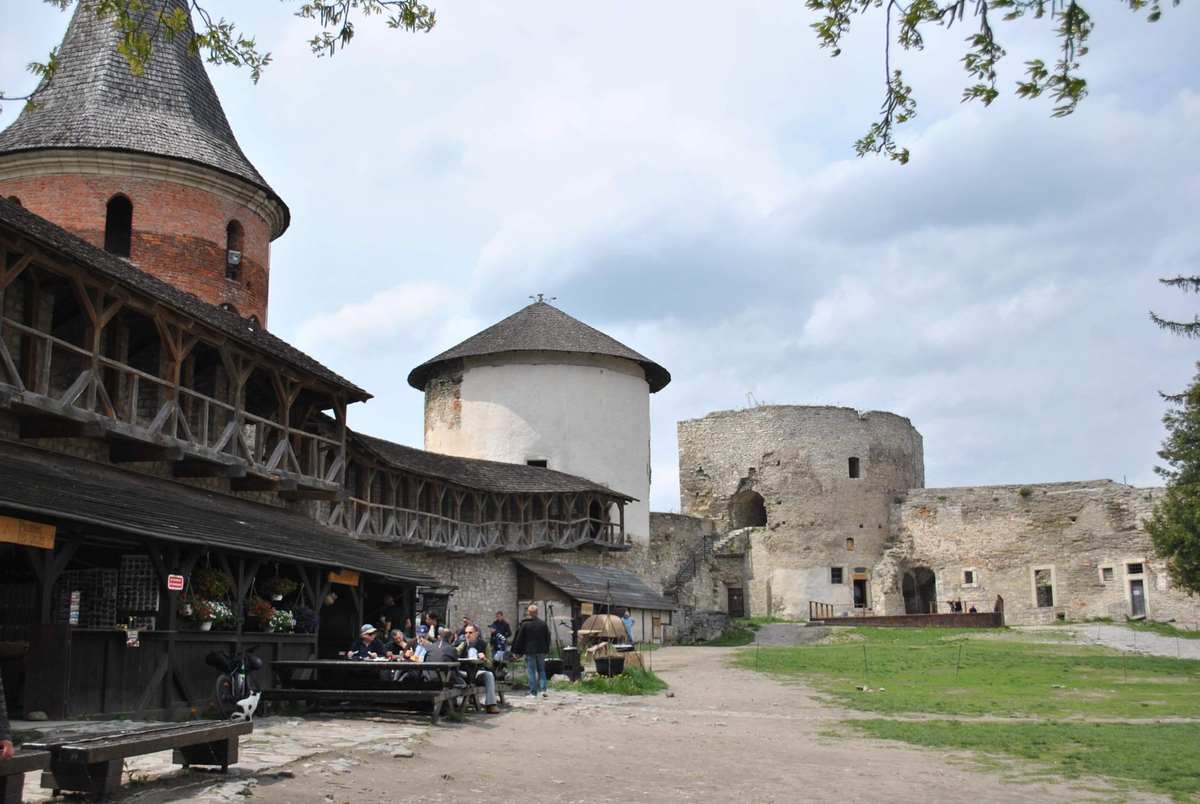 cour intérieure du château avec herbe, tables et personnes